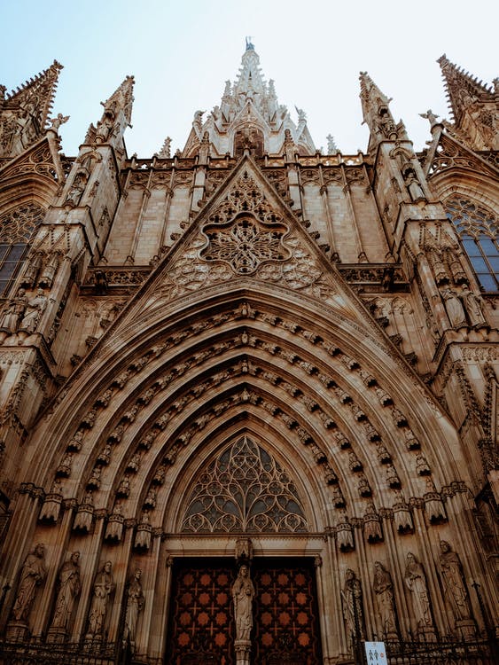 a grand cathedral, taken from a huge doorway, looking upwards to the spires