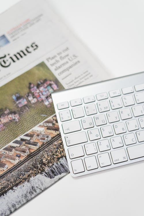 a newspaper with a keyboard placed on top of it