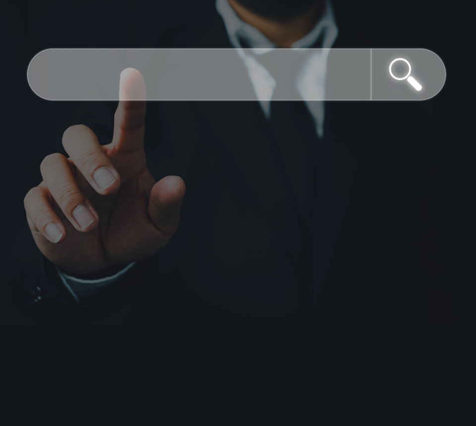 a man in a black business suit in pressing on a grey search bar to enter information